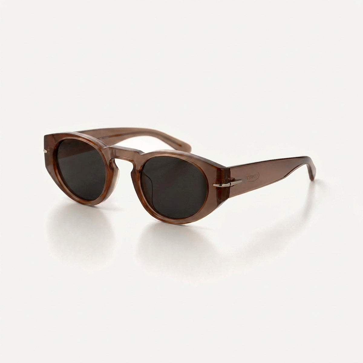 Tyffco Chloe sunglasses in Amber, three-quarter view showing the TYFFCO mark on the temple, studio on off-white background.